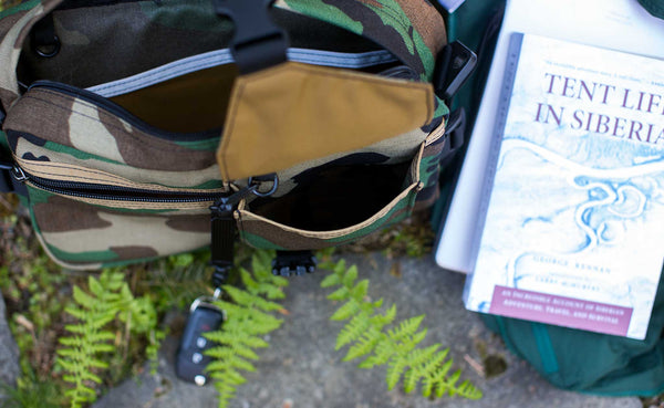 Photo of the LGD in Beaver Camo 1000d. The buckle front pocket is open, showing how it has at least 2-1/2" of depth!